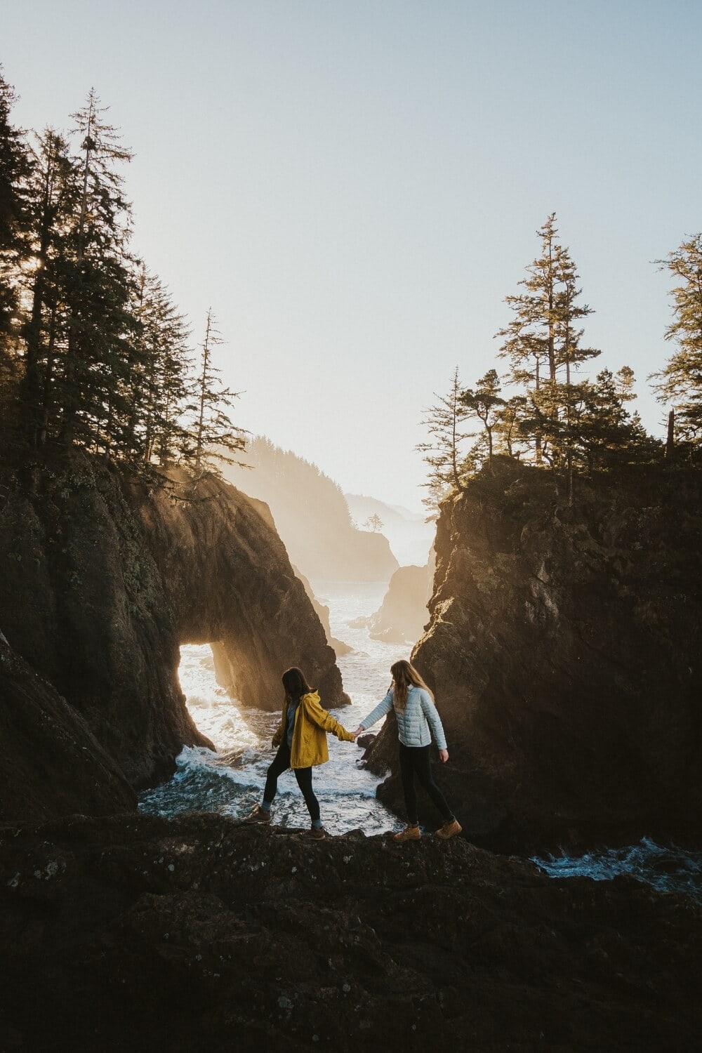 girls watching sunrise over natural bridges Samuel H. Boardman State Scenic Corridor