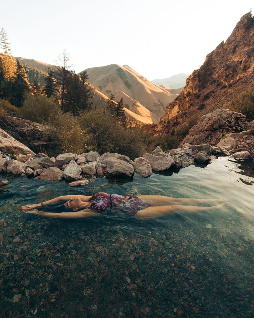 girl floating in goldbug hot springs in idaho
