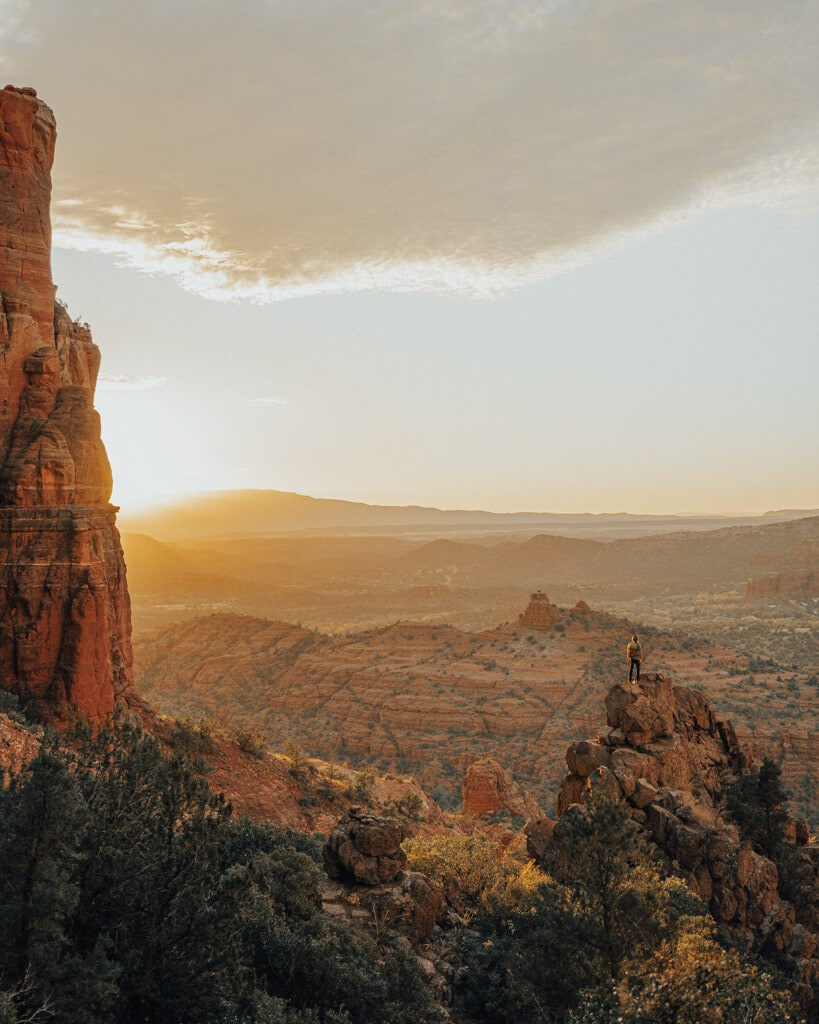 view of a bright orange and gold sunset from the top of cathedral rock sedona