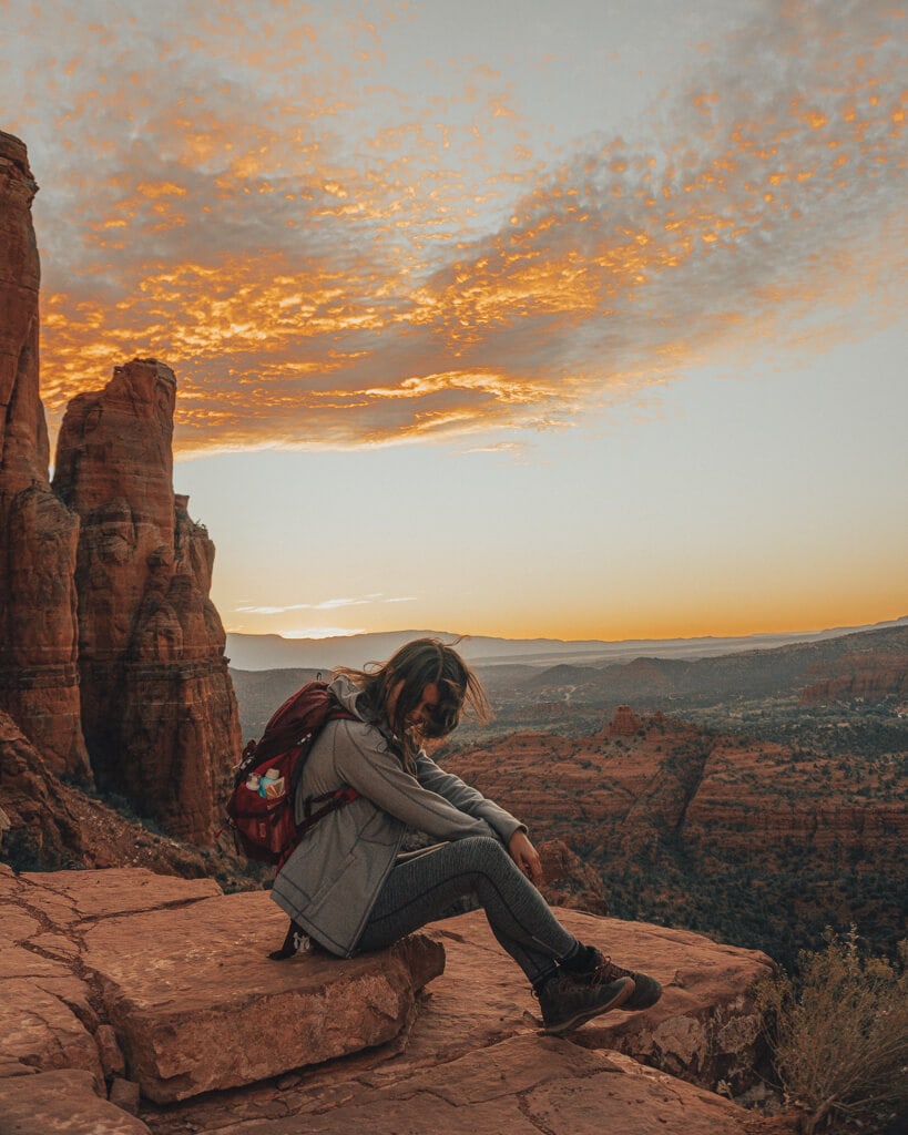 female hiker watching the sunset from cathedral rock