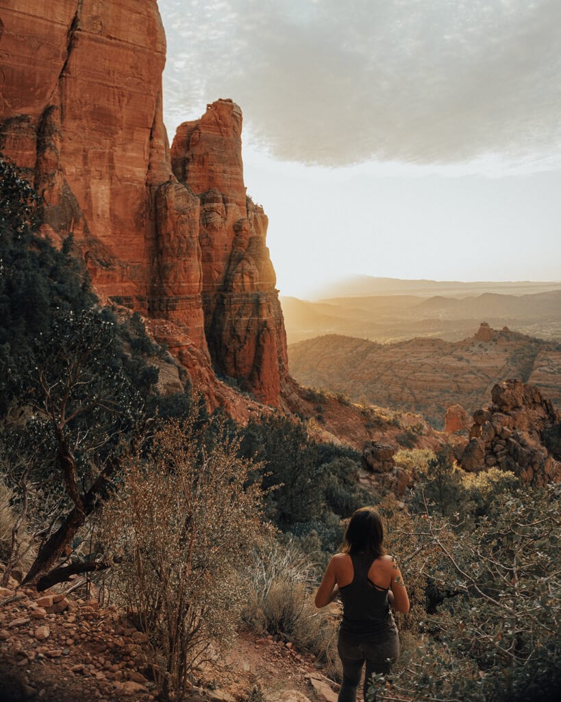 girl standing at Cathedral Rock at sunset
