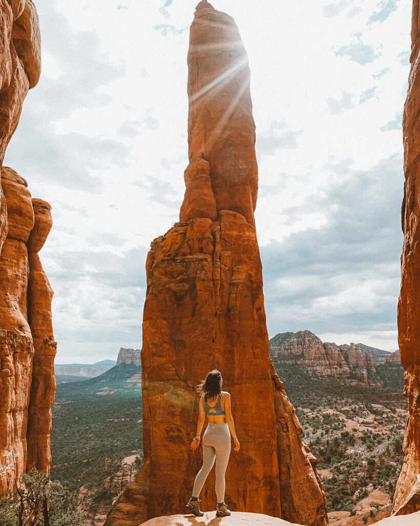 female hiker looking at the cathedral rock pillar in sedona arizona