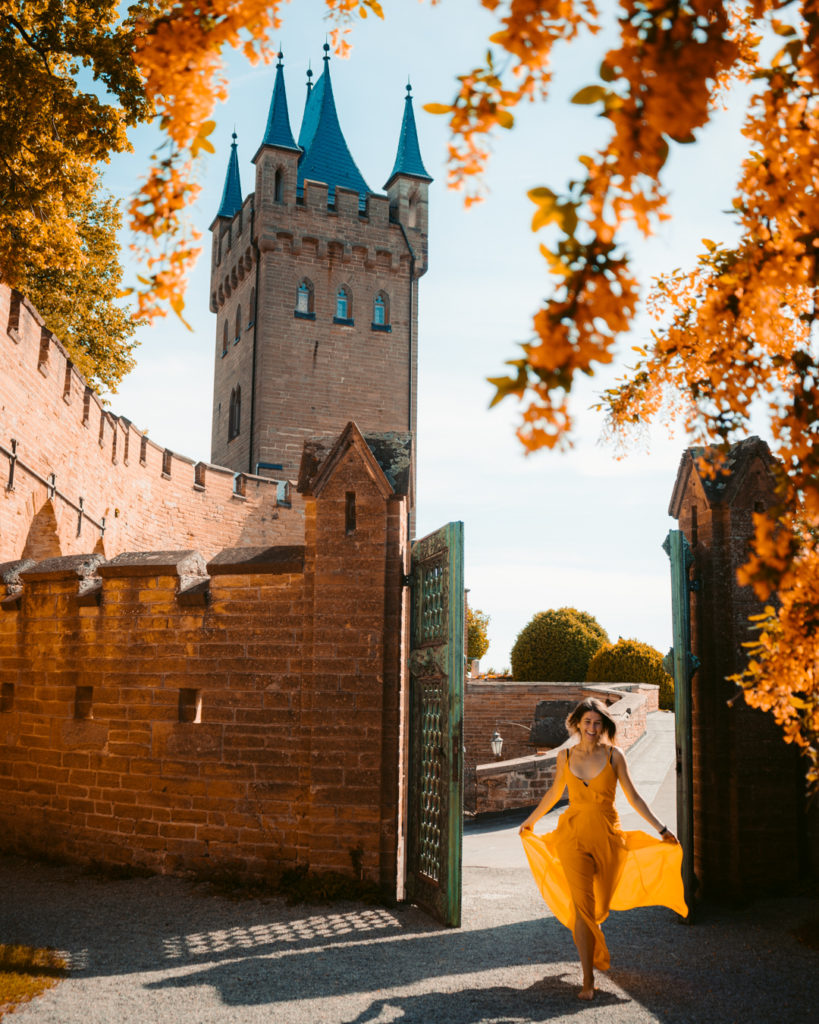 girl in a yellow dress running through Hohenzollern Castle germany
