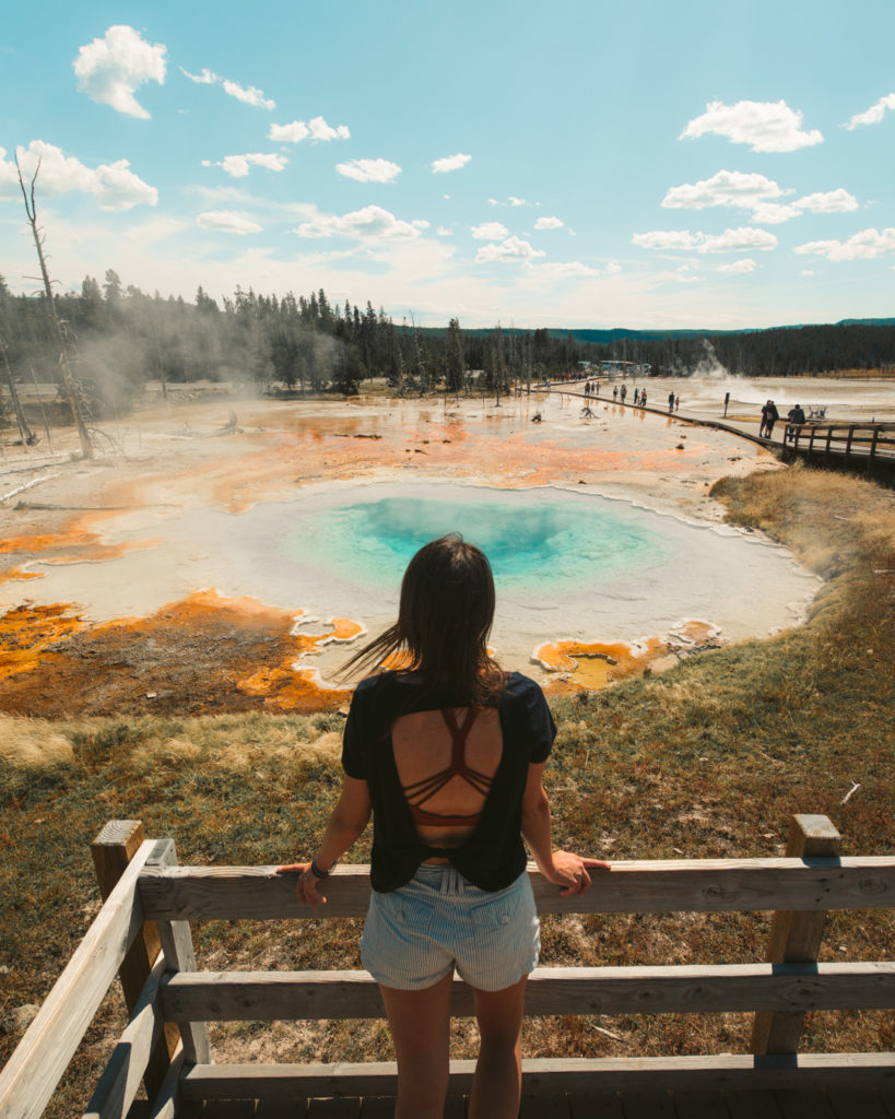 girl visiting  geyser in Yellowstone National Park