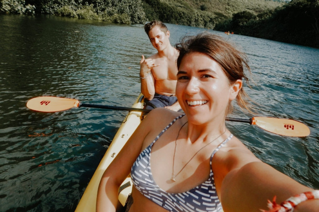 Girl and boy kayaking on the Wailua River in Kauai Hawaii