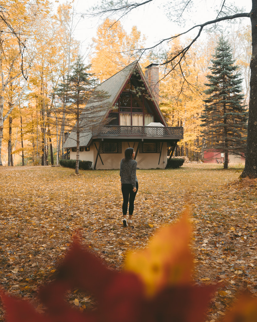 Girl walking to cabin in North Conway with fall foliage