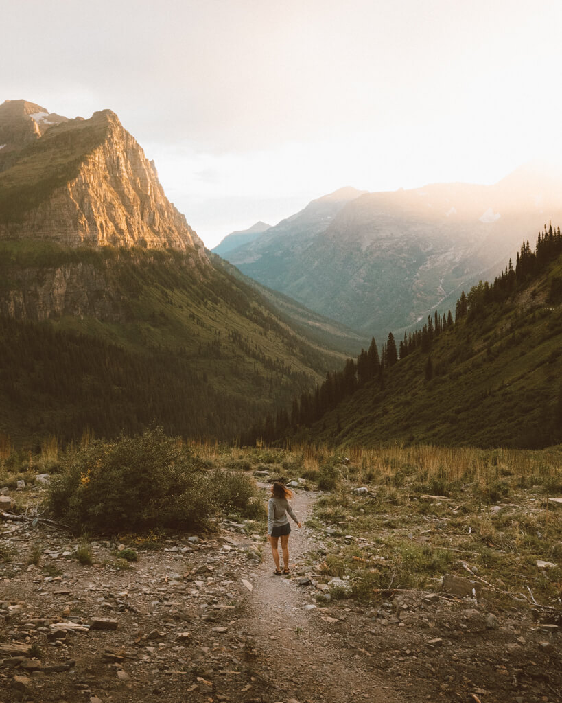 female hiker watching sunset from Big Bend on Going to the Sun Road in Glacier National Park