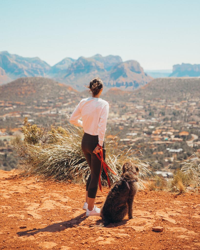 female hiker and her brown dog on sugar loaf summit trail sedona