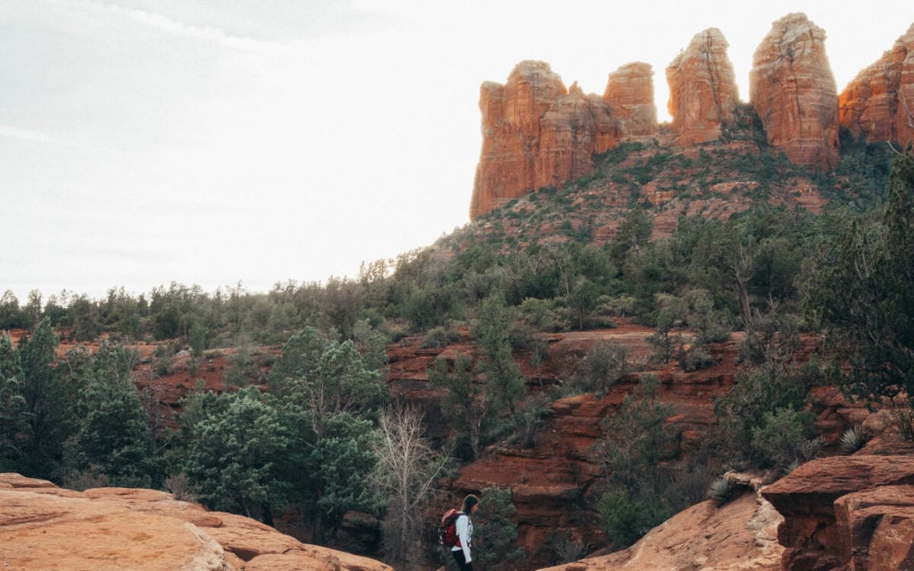 female hiker admiring red rocks from soldier pass trail sedona