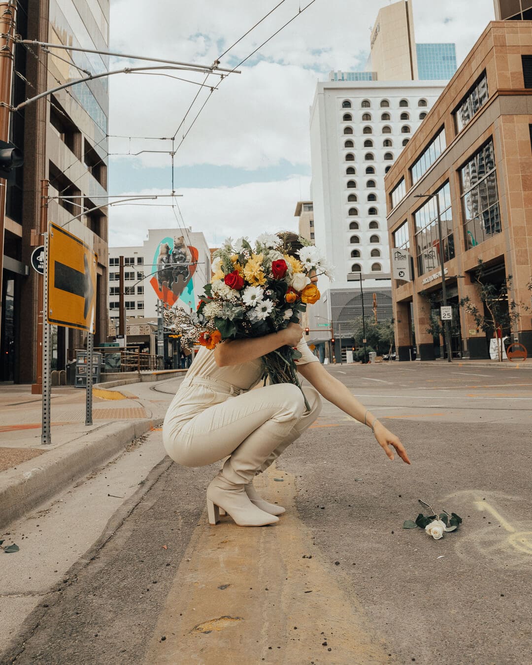 Girl holding flowers on an instagrammable street in downtown phoenix arizona