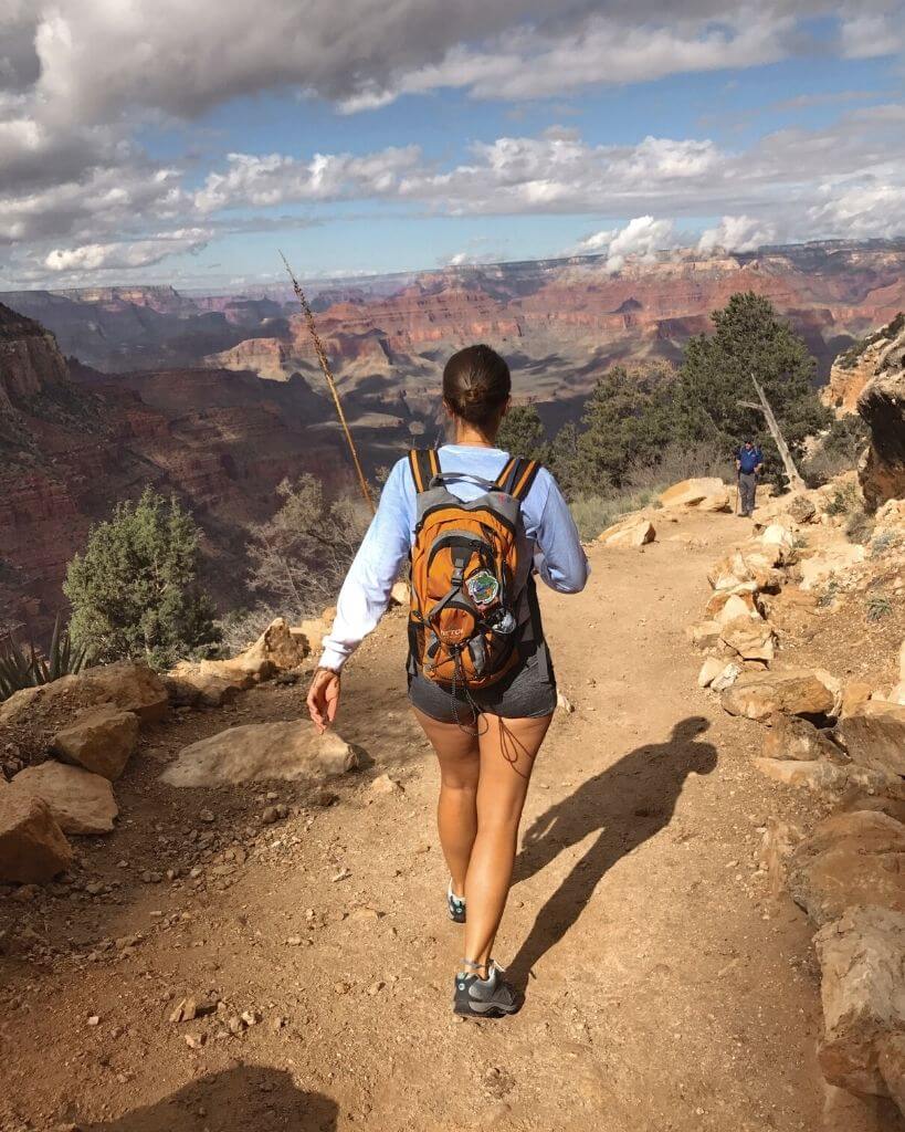 female hiker walking down south rim trail in grand canyon national park az
