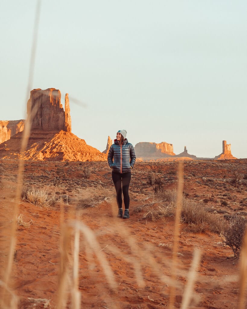 female watching the sunrise from monument valley's valley drive utah