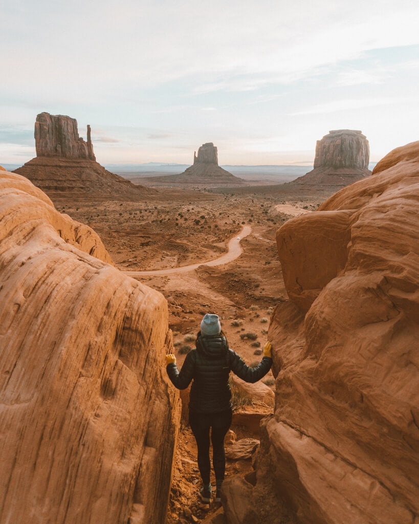 female watching the sunrise over monument valley mittens utah