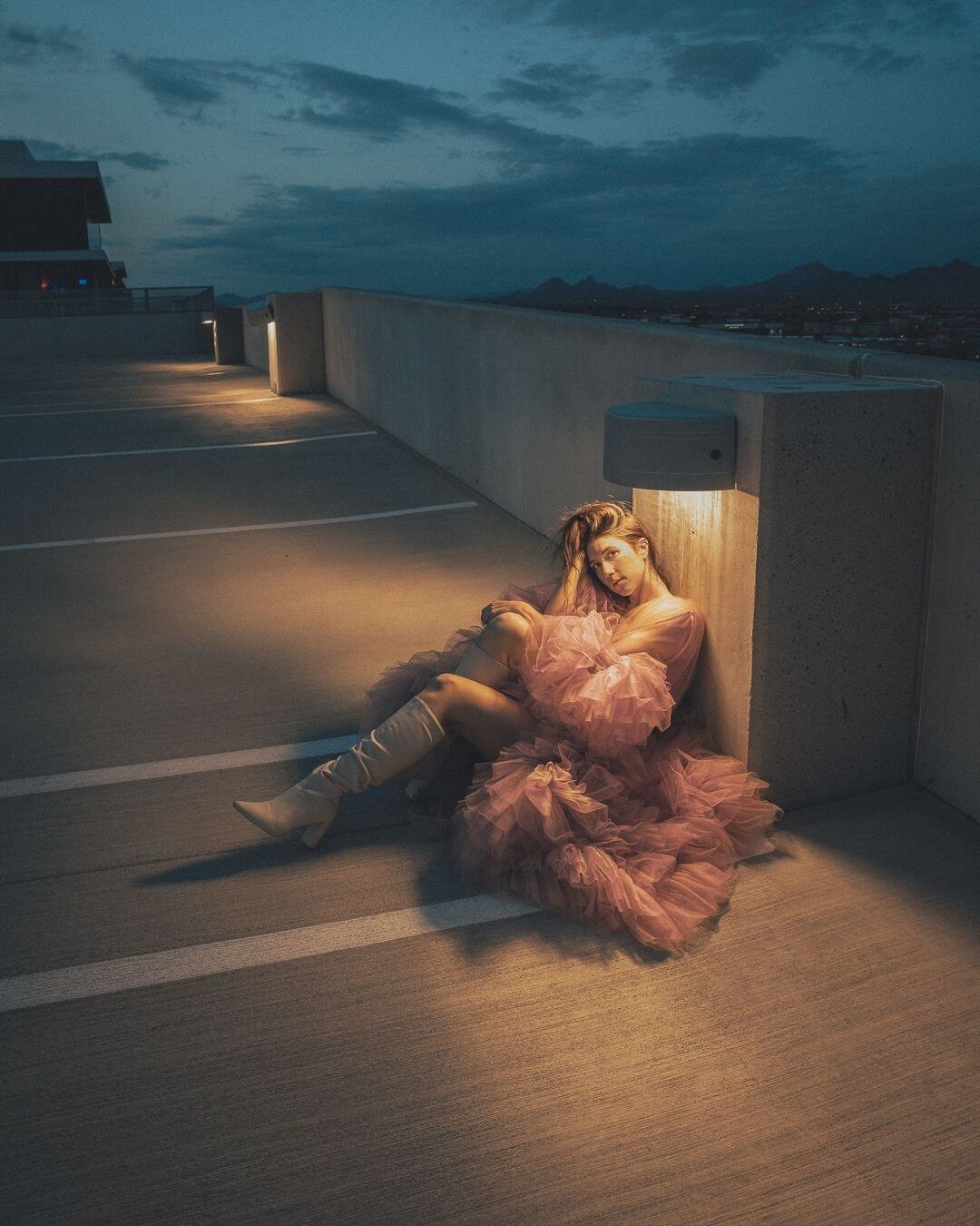 girl sitting in a Scottsdale Quarter parking garage in a pink dress