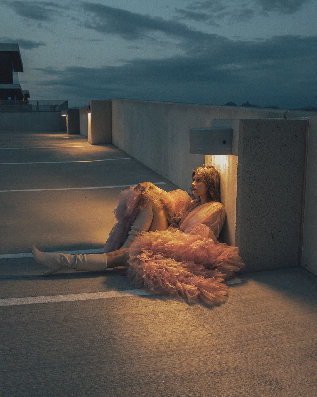 girl sitting in a Scottsdale Quarter parking garage in a pink dress