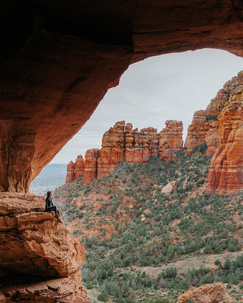 girl looking at the view from keyhole cave sedona
