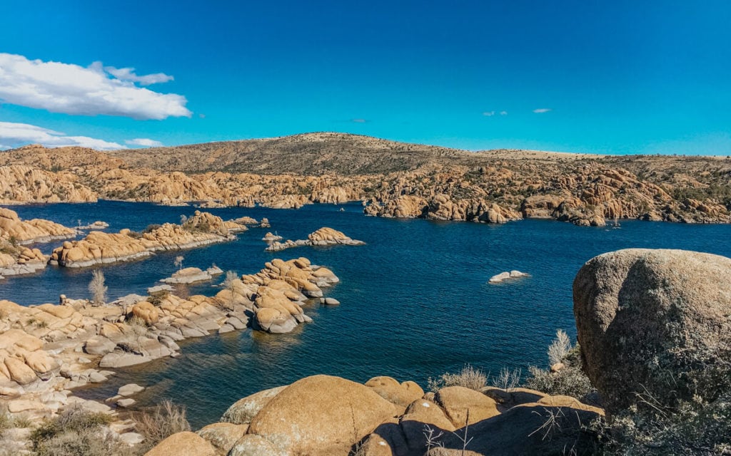sunny day and bright blue sky over the boulders along watson lake in prescott arizona