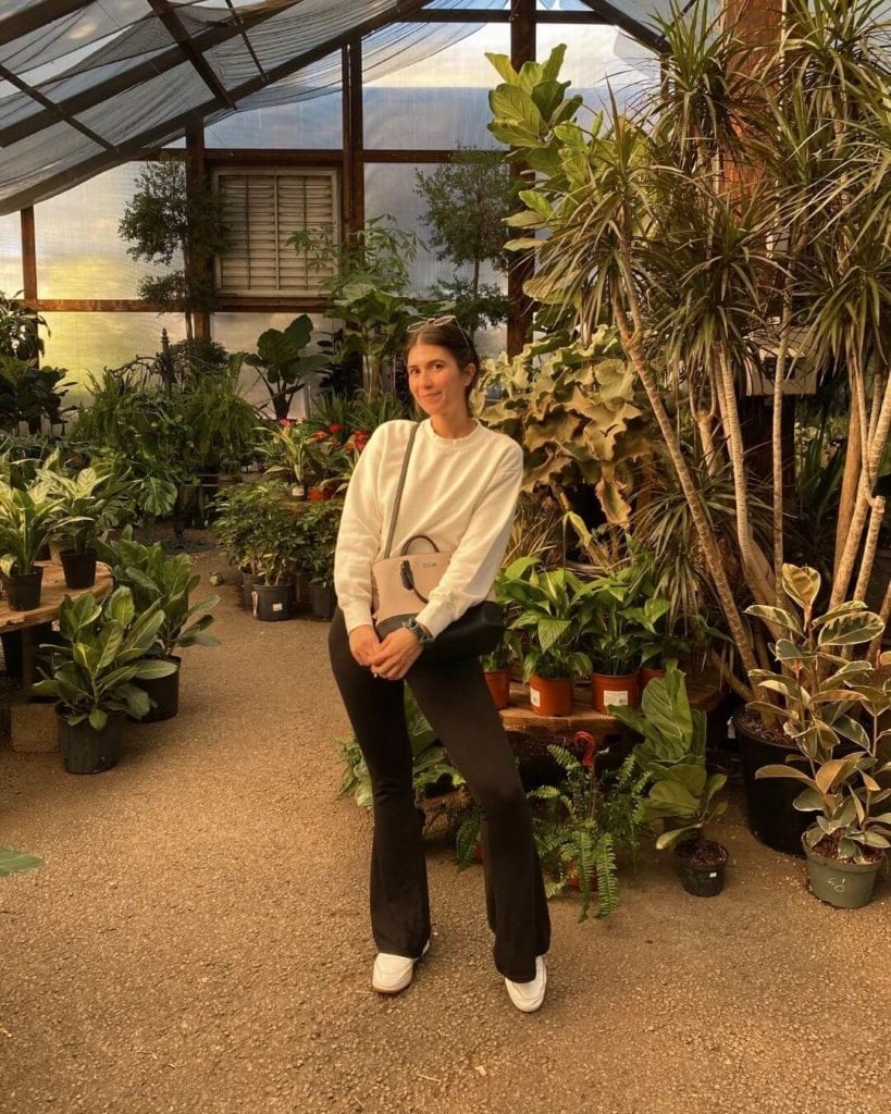 girl taking a instagram photo in whitfill nursery in phoenix arizona