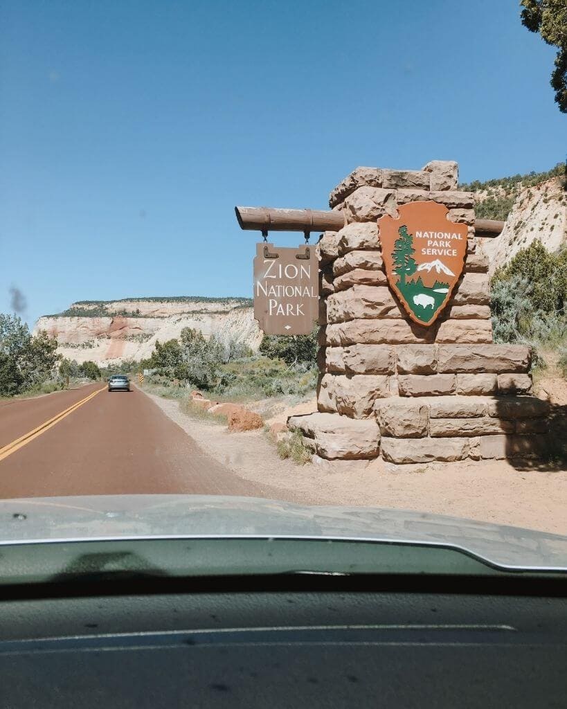 view of orange Zion National Park entrance sign in utah