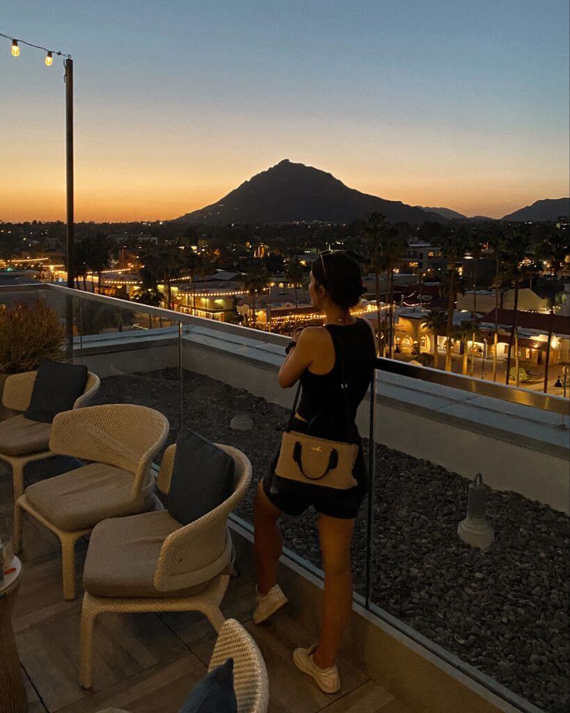 girl standing on outrider rooftop lounge in scottsdale arizona