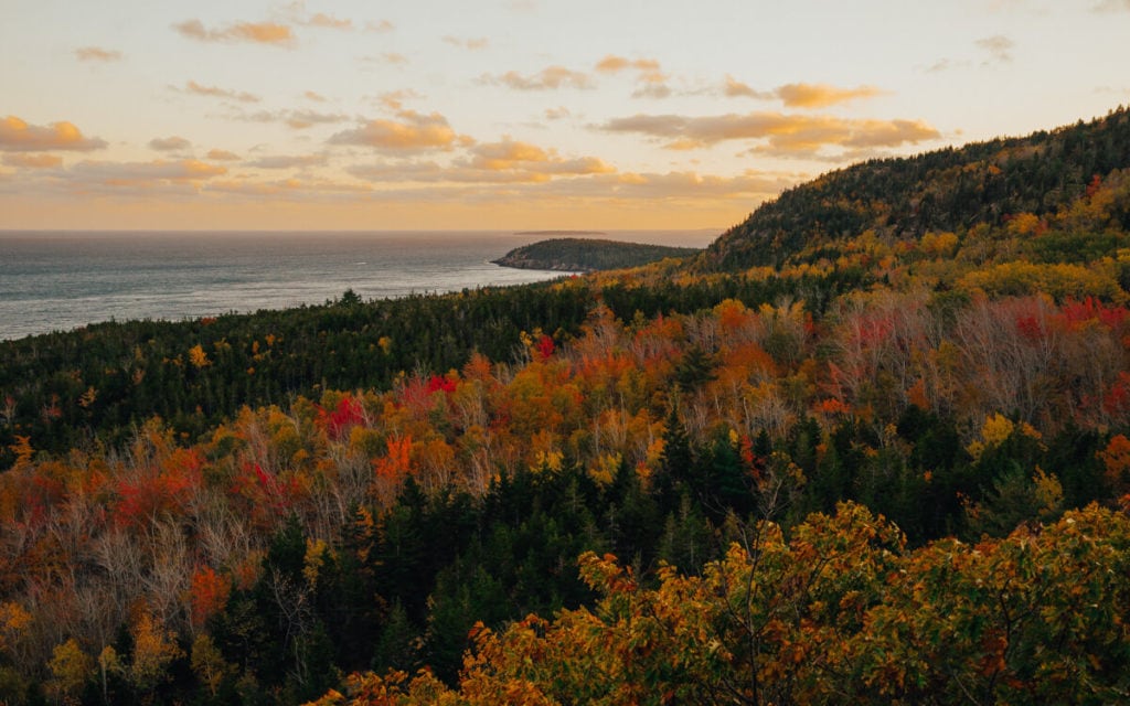 view of a pink sunset over acadia national park maine in the fall