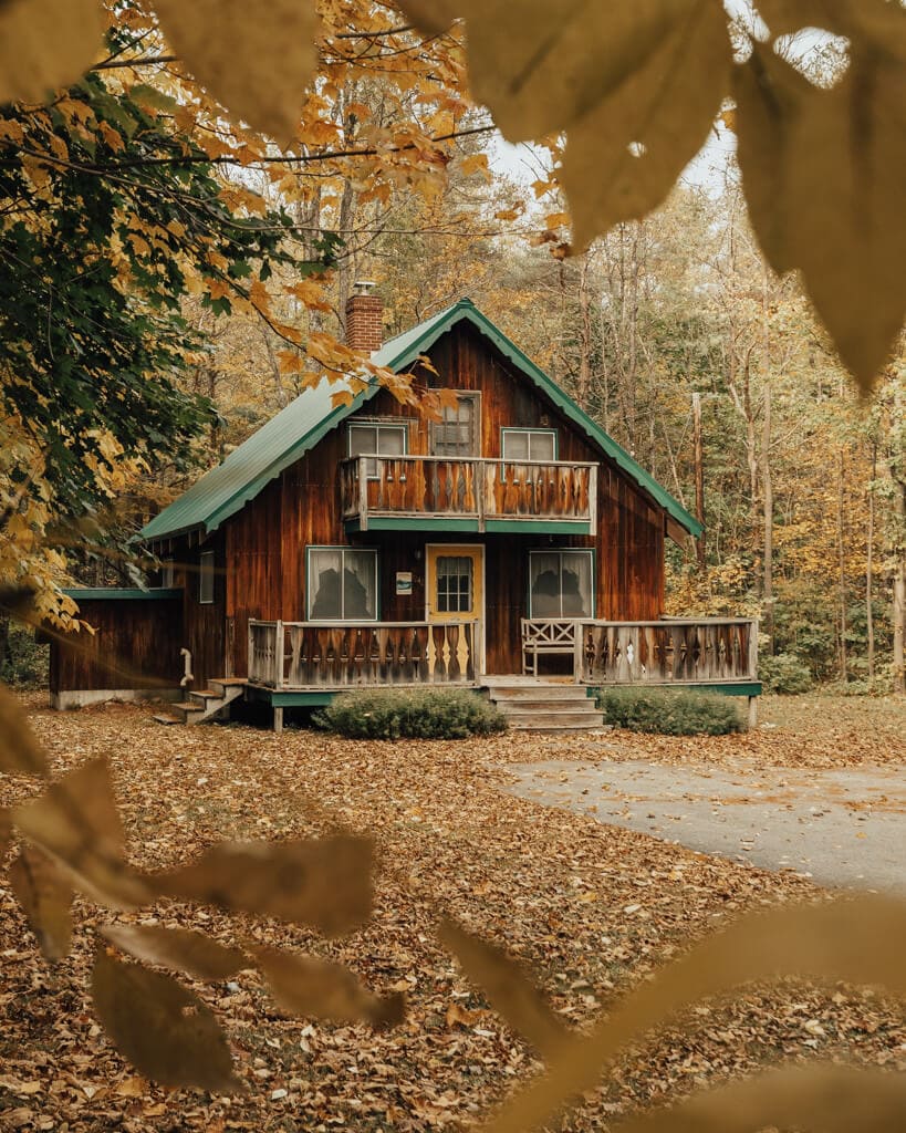 cabin surrounded by yellow new england fall foliage