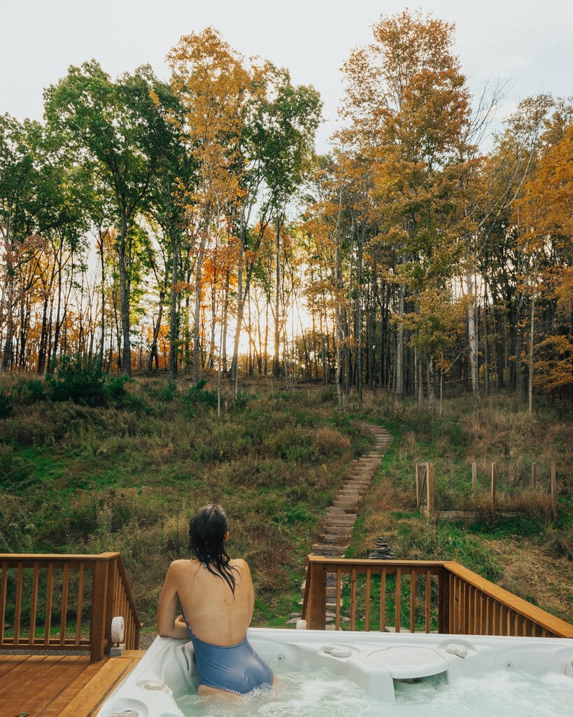 girl looking at fall foliage from a cabin in Lake Minnewaska new york area