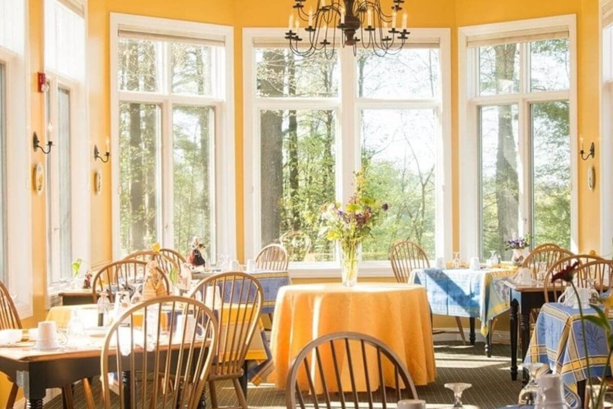 view of the yellow dining room in the stone hill inn, stowe