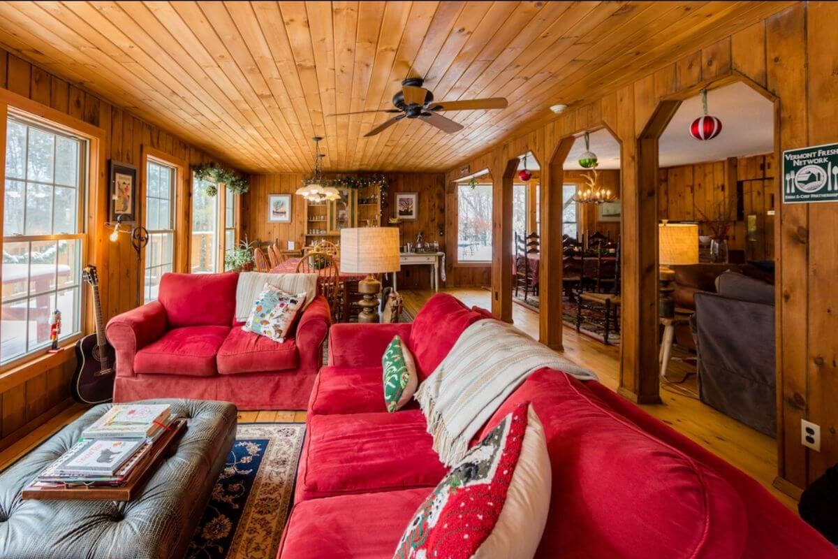 view inside the lodge area with a red couch in stowe's timberholm inn