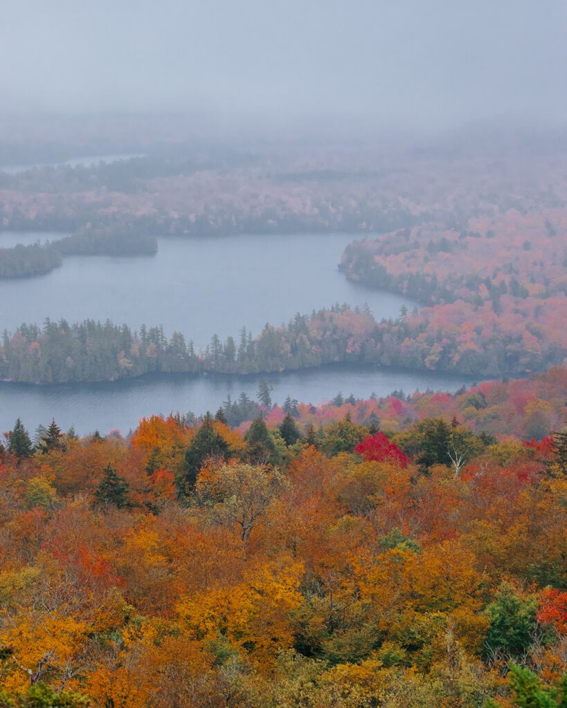 fall foliage in the adirondack mountains along mirror lake