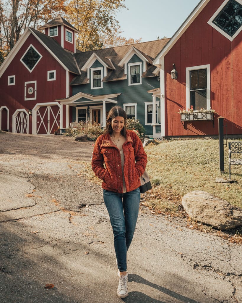 girl walking along main street in stowe vermont in the fall