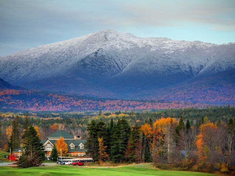 snow capped mount washington surrounded by fall foliage in new hampshire