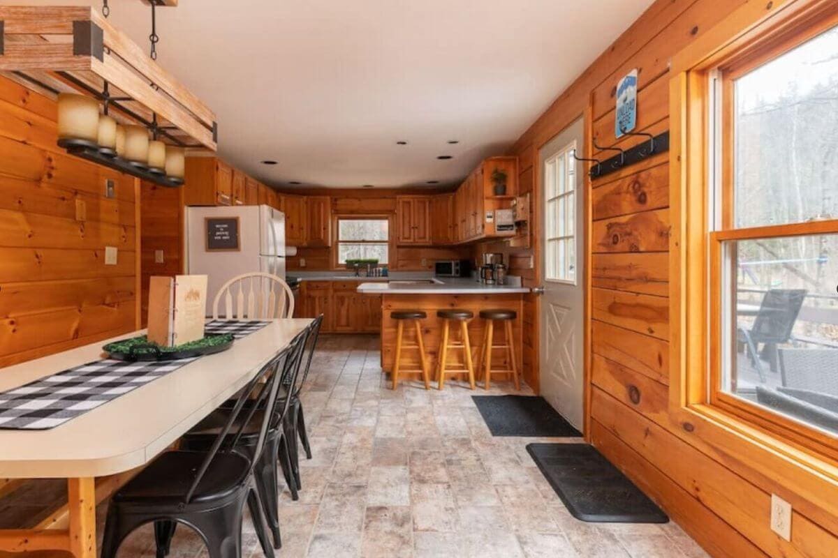 inside a stylish wooden cabin rental in north conway new hampshire with an open kitchen