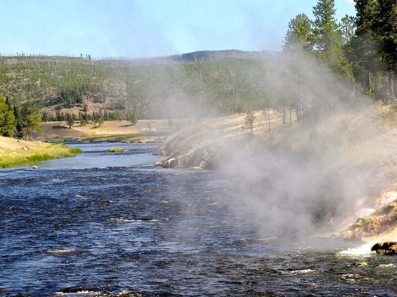 sunny day over the blue boiling river hot springs in yellowstone national park