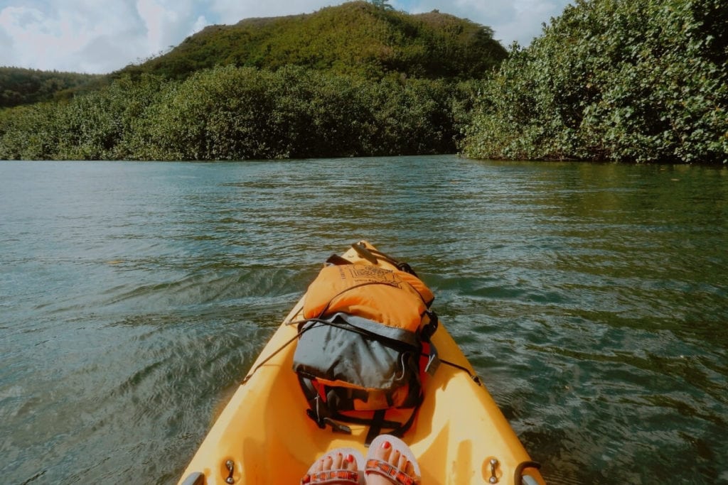 Girl kayaking on the Wailua River in Kauai Hawaii