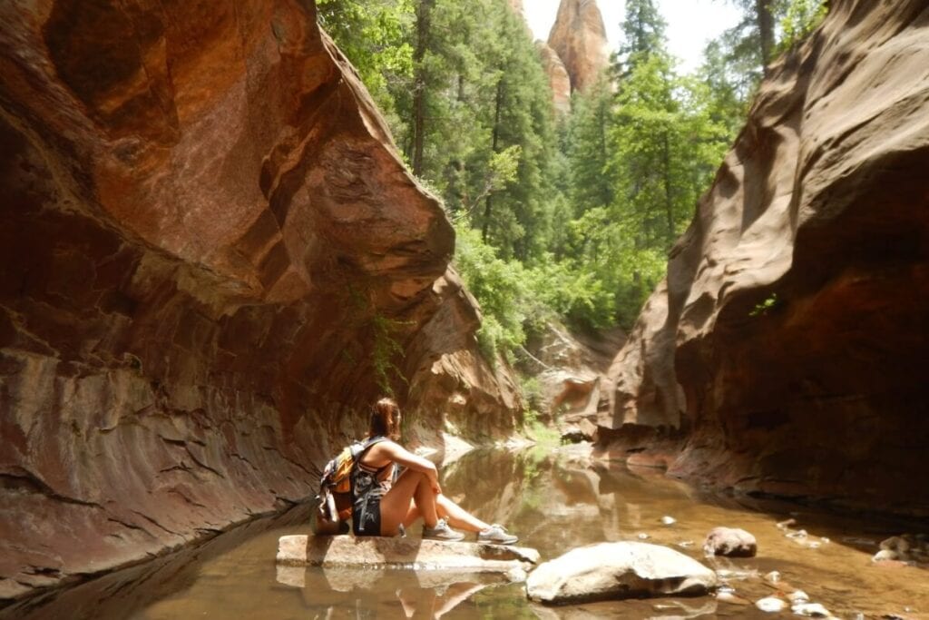 female hiker looking at the canyons walls in west fork oak creek canyon sedona