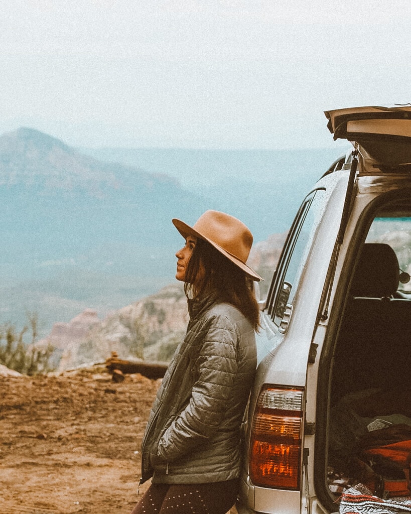 female camper wearing a brim hat looking out at a view in sedona az