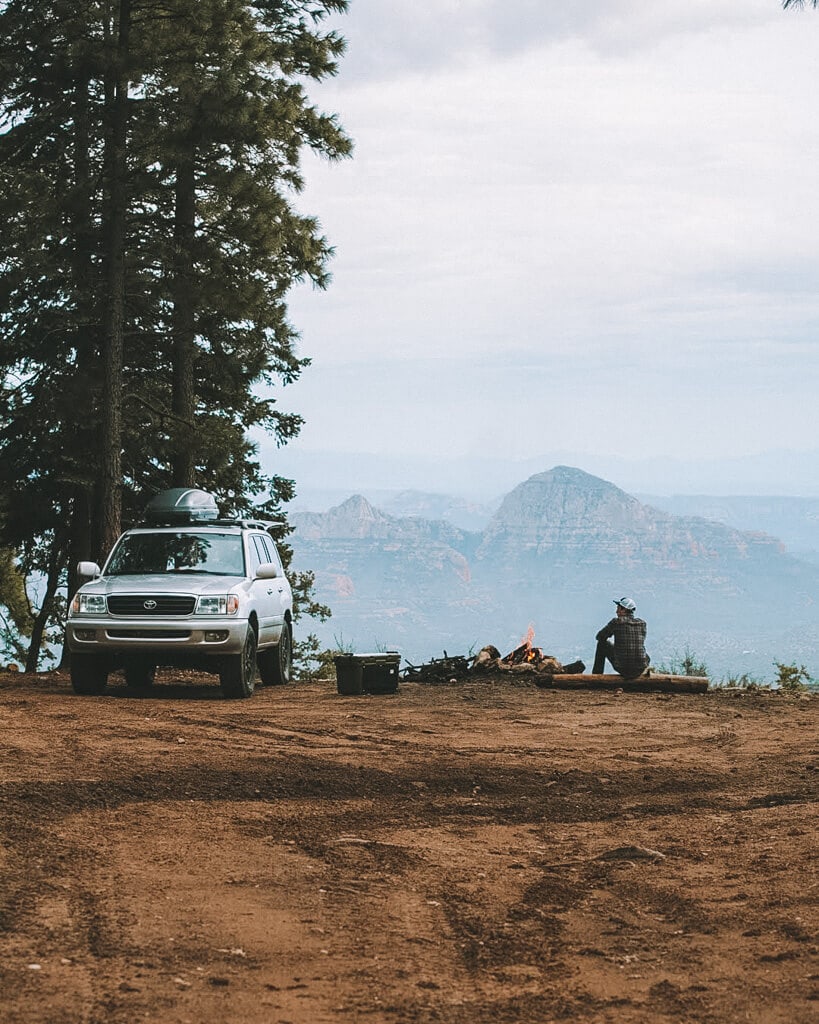 male camper and his land cruiser near a campfire on east pocket arizona