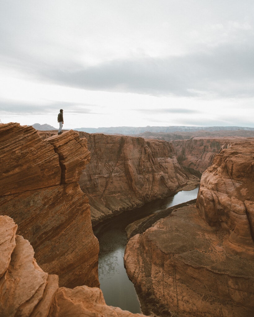 male looking at the view from the top of horseshoe bend arizona