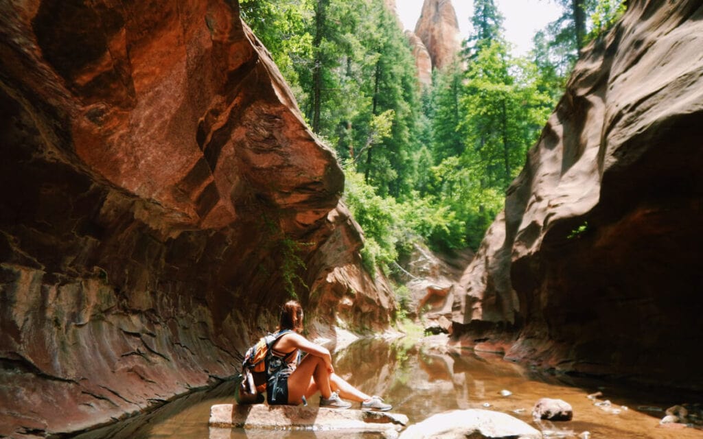 girl sitting in front of Oak Creek Canyon