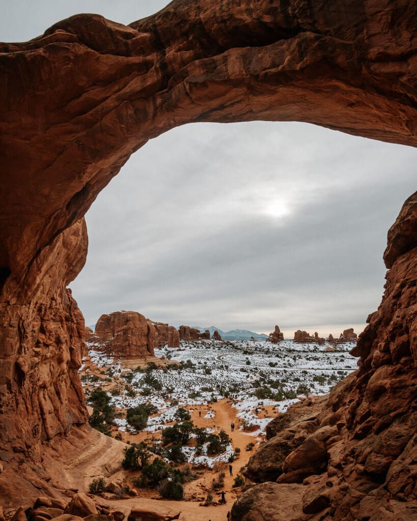 winter sunrise over double arch in arches national park utah