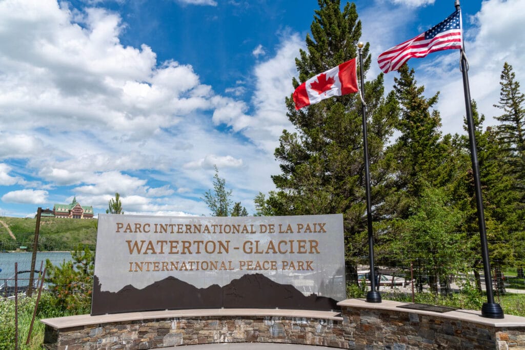 sign in front of waterton glacier international peace park