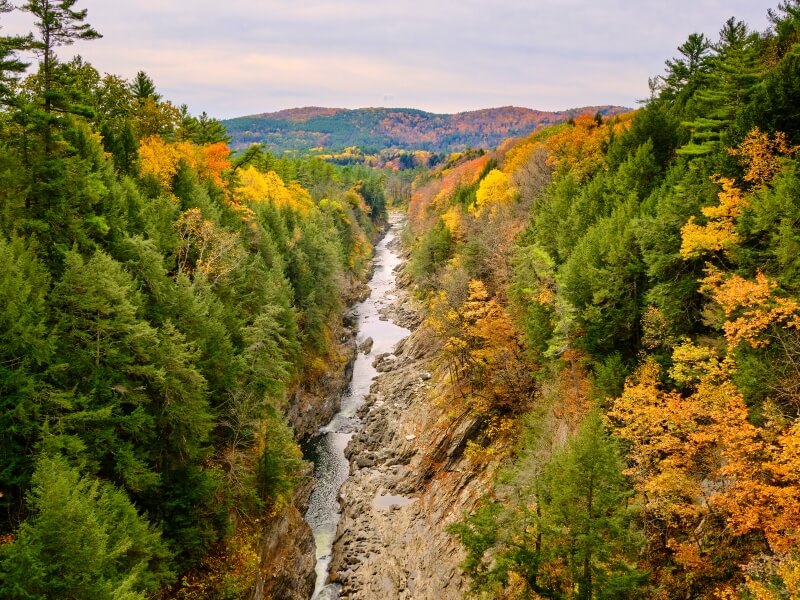 Quechee Gorge in woodstock vermont surrounded by orange fall foliage