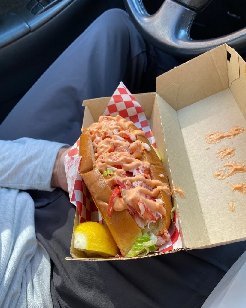 large lobster roll with spicy sauce from highroller in portland maine