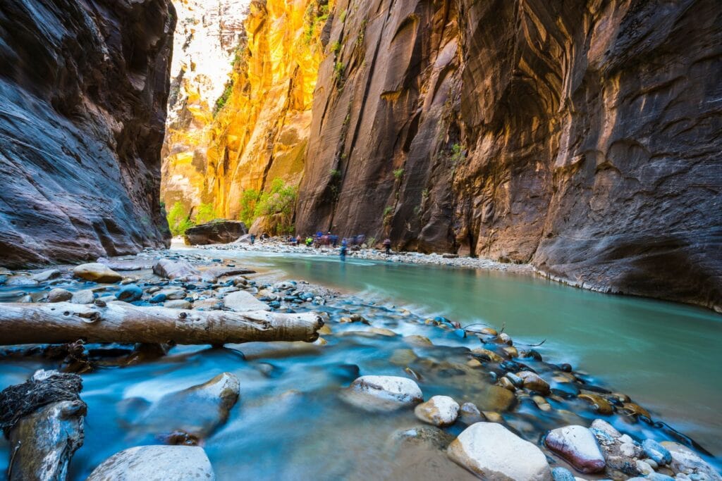 bright blue water flowing through the narrows in zion national park