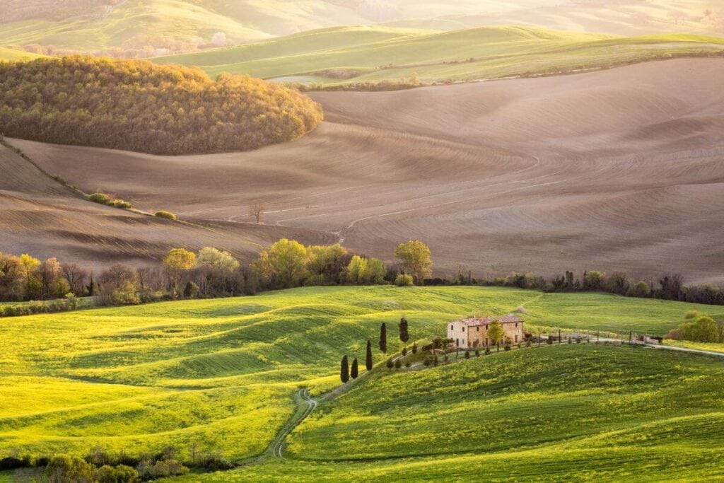 sunrise over the green hills of Pienza Tuscany italy