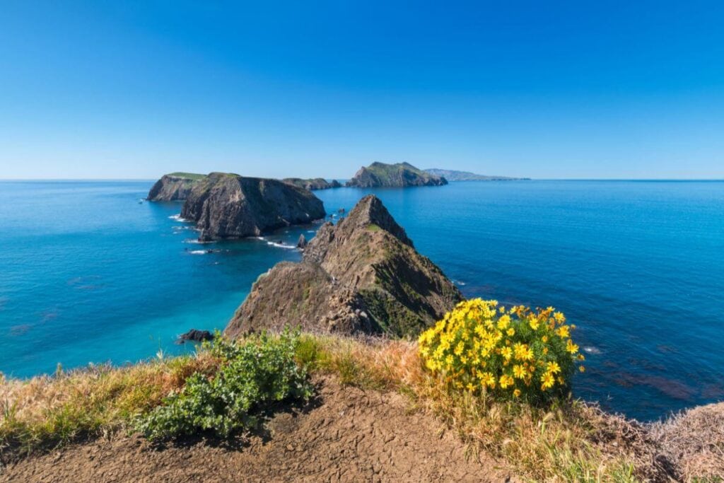 blue skies and bright blue ocean water flowing past channel islands national park california