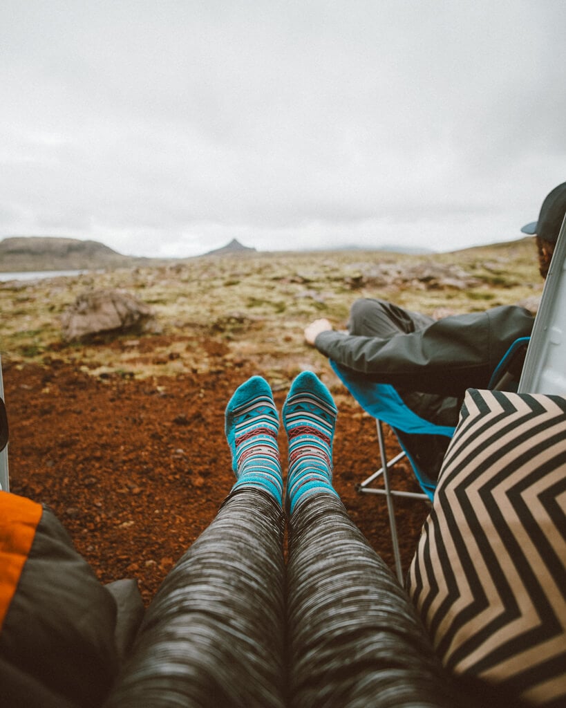 female wearing blue socks while she explores iceland in a campervan