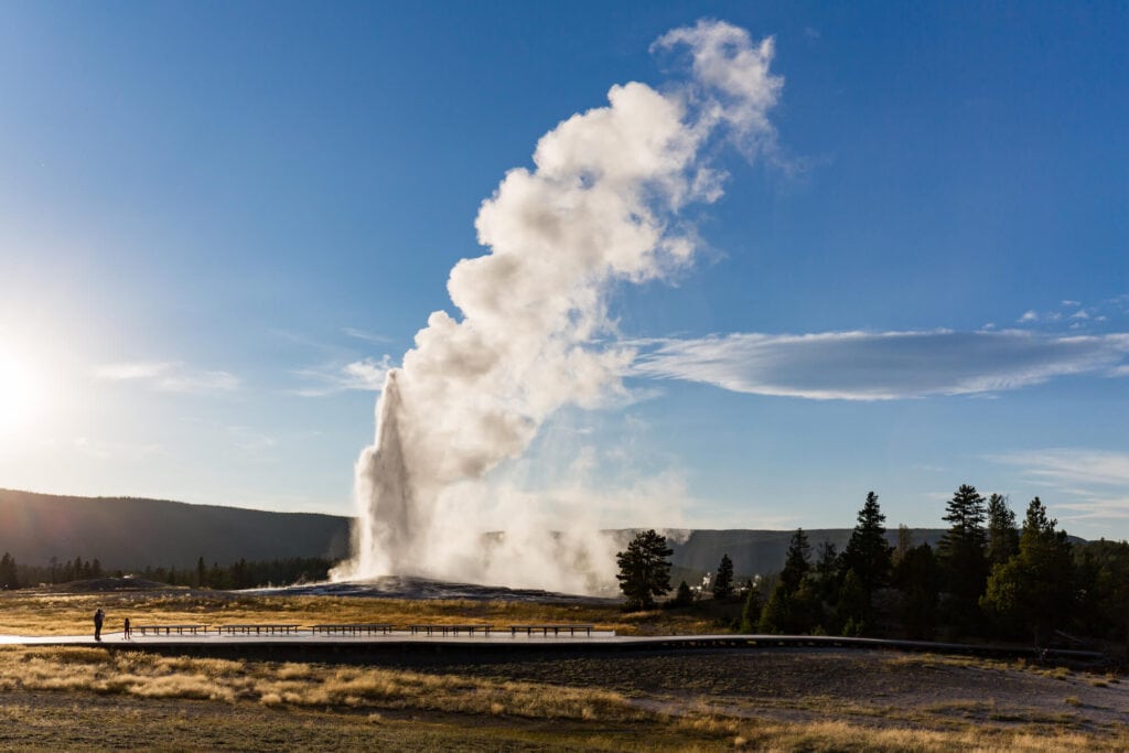clear blue skies over the old faithful geyser in yellowstone national park