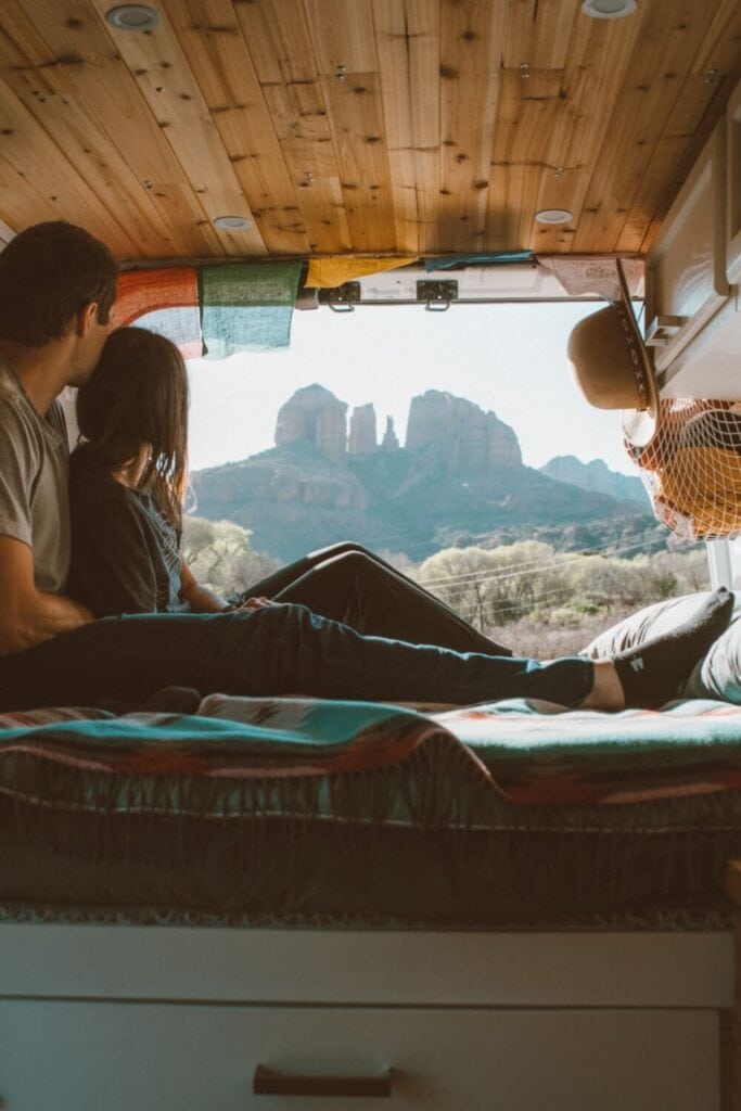 male and female in a campervan in sedona looking at cathedral rock